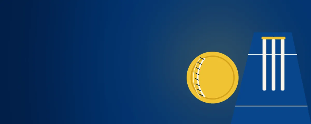A cricket ball beside the stumps